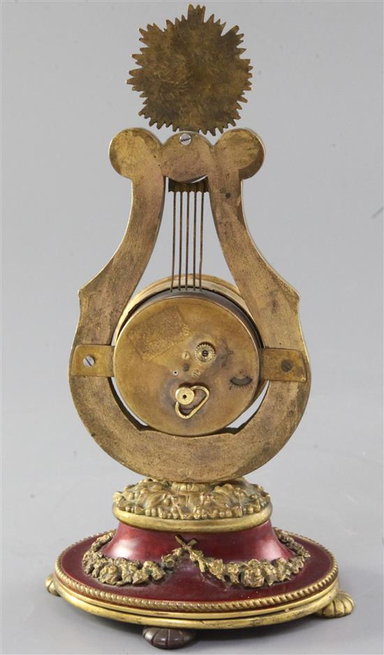 A French enamelled gilt metal lyre shaped timepiece, 22cm